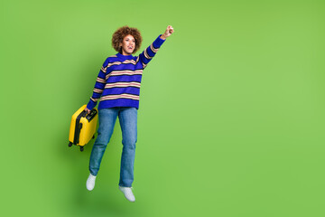 Canvas Print - Photo of glad funny tourist wear blue striped trendy clothes hold valise hurry empty space isolated on green color background