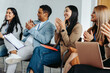 © Jacob Lund - Diverse business meeting with colleagues clapping in office setting