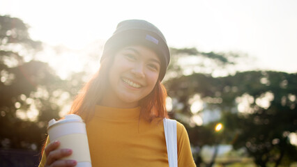 Go green Gen Z woman asia young people smile looking at camera protect save the earth planet world care in city tree public park. Asian hope net zero waste reduce social issues by reuse eco tote bag.