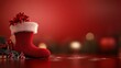 © Nathamanee - A red stocking sits on a table with a red background
