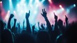 © Dulemegapixel - A vibrant, colorful cheering crowd with arms raised at an electrifying concert, capturing the dynamic energy and mood of a night filled with music and joy.