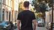 © Vergiliy - Man walking down street in black t-shirt