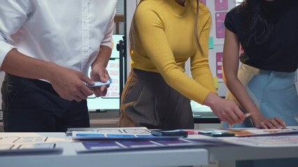 Wall Mural - designers discussing the user interface of a mobile application during a meeting in an office settin