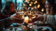 © Meow Creations - Celebrating Christmas,  Friends toasting with glasses of white wine during festive holiday dinner with blurred Christmas tree lights in background. Concepts of togetherness and Christmas cheer