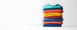 © DonChanu - Colorful Folded T Shirts Stacked on White Background