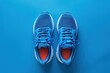 © Your Choice - Blue athletic shoes viewed from above on a vibrant blue background