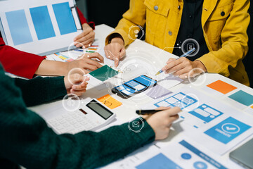 Wall Mural - close up view of ui developer team brainstorming on their project with laptop, smartphone and digita