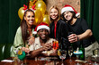 © LIGHTFIELD STUDIOS - A group of young diverse colleagues toasts with colorful drinks during a festive celebration.