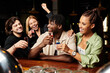 © LIGHTFIELD STUDIOS - A cheerful group of young professionals enjoys shots and laughter during a corporate celebration.