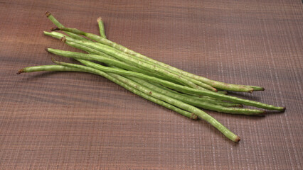 French beans with stewed green peas on wooden background. Healthy food concept.