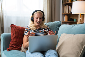 Young woman talking on video call with her psychotherapist doctor after online therapy sessions, happy that she is well and mentally health now after telemedicine conversations.