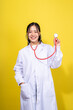 © Wasana - A woman in a white lab coat holding a stethoscope