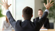 © Nakarin - man stands with arms raised in frustration during meeting, expressing strong emotions while facing two colleagues. atmosphere is tense and dynamic