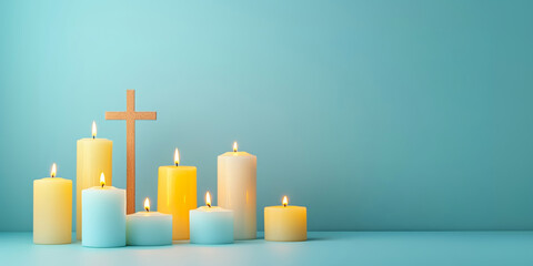 Burning candles and wooden cross on blue background with copy space. All Saint's Day, All Souls' Day, Easter, Christmas, Christian background.