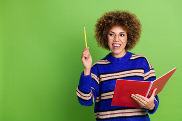 Canvas Print - Photo of lovely charming woman wear blue striped stylish clothes hold textbook look empty space isolated on green color background