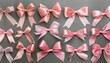 © netsay - Collection of various pink satin bows arranged neatly on a gray background showcasing diverse shapes and sizes for crafting and decoration