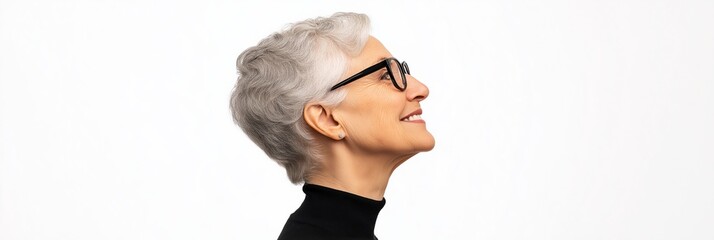 A woman with short gray hair and glasses is smiling. She is wearing a black shirt and a black vest