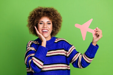 Canvas Print - Photo of charming nice woman preparing for travel wear blue striped stylish clothes advertise plane isolated on green color background