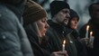 © VK Studio - A solemn group holds candles during a reflective vigil, expressing unity and contemplation in the fading light.