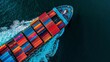 © Shutter2U - Aerial view of a large cargo ship carrying colorful containers on the ocean.