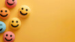 © Shutter2U - Colorful smile faces on a yellow background with copy space.