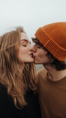 Wall Mural - A couple kissing with a man wearing a brown hat