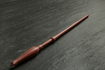 One old magic wand on black table, closeup