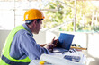 © Have a nice day  - Caucasian Male architect engineer construction worker using computer laptop working on blueprint design plan using pencil tool analyzing design innovation building landscape housing architecture.