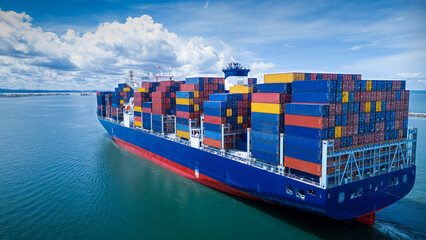 stern view of cargo container ship carrying container and running out international container port c