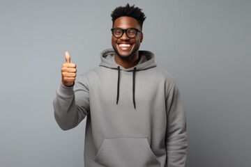 Wall Mural - Black man wear glasses and grey hoodie hold clipboard sweatshirt portrait smile.