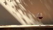 © Y_Malashkevych - A Bordeaux wine glass rests on a wooden surface, illuminated by gentle afternoon light, creating a serene and minimalist ambiance perfect for wine appreciation