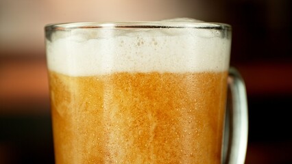 Close-up of beer pouring into pint , freeze motion.