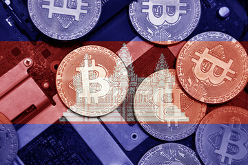 flag of cambodia on the bitcoins with computer electronic circuit board background. bitcoin concept.