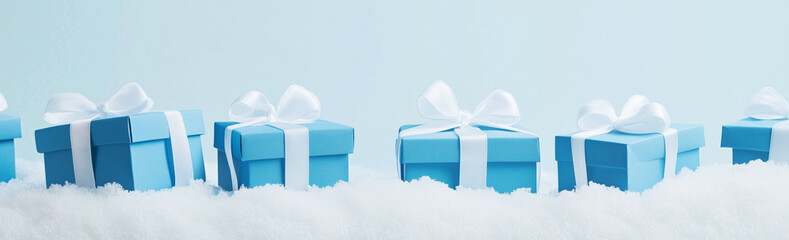 Wall Mural - a row of blue boxes with white bows on top of a snowy background