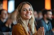 © Art_You - Smiling young woman in audience clapping and enjoying a lively presentation with enthusiasm and joy