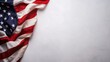 © zhou yan - A detailed top view of the American flag placed on a clean white background with ample copy space, symbolizing the United States of America and its national pride. Perfect for celebrating U.S. holiday