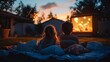 © Pornsurang - Family gathered in the backyard for a movie night, streaming a film on a portable projector, cozy atmosphere with blankets and pillows under the evening sky
