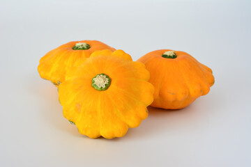 group of orange pattypan squashes isolated on the white background 