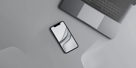 Modern smartphone lying near laptop on gray desk with abstract background