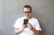 © Rimba - Smiling Man Using Smartphone, Happy Mobile Phone User,  Positive Technology Experience