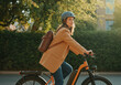 © Running opossum - Young female professional commuting to work on her e-bike, enjoying a sustainable and efficient mode of transportation
