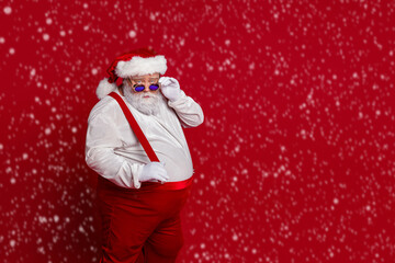 Sticker - Photo of cool serious overweight man take off retro specs wear santa hat costume isolated red color background