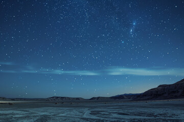 A clear night sky with a few stars and a large cloudless sky