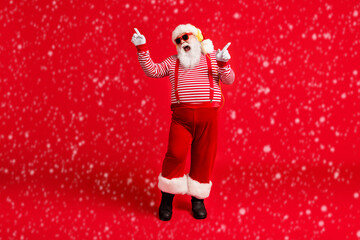 Poster - Full length body size view of his he handsome bearded fat overweight cheerful glad Santa fan listening single melody dancing having fun rest isolated bright vivid shine vibrant red color background