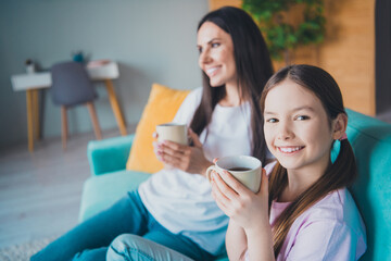 Wall Mural - Photo of cute nice pretty mommy and sweet small daughter drinking tea relax rest weekend indoors living room