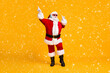 © deagreez - Full size photo of crazy santa claus with white beard listen headset x-mas christmas music dance wear sunglass headwear cap isolated over bright shine color background