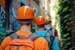 © Ilja - Team of Three Construction Workers Walking on Site, Wearing Hard Hats and Safety Gear