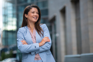 Wall Mural - Portrait of business woman standing outdoor in blue suit