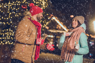 Canvas Print - Photo of two excited positive partners hold champagne speak communicate december lights outdoors