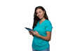 © PeopleVideos - Portrait of a young nurse in scrubs holding a tablet